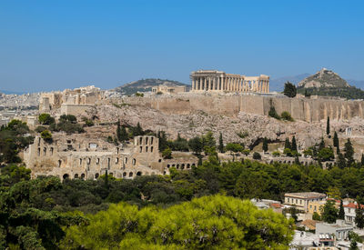 Buildings in city against clear sky