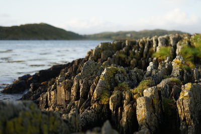 Rocks on beach against sky