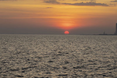 Scenic view of sea against orange sky