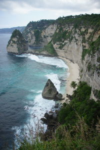 Rock formation in sea against sky