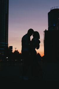 Silhouette couple against sky during sunset