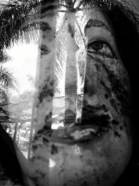 Double exposure of woman and trees against sky