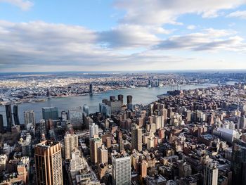 High angle view of cityscape against cloudy sky