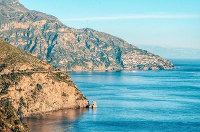 Scenic view of sea and mountains against sky