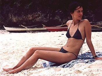 Rear view of young woman sitting outdoors