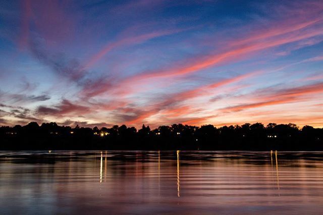 sunset, water, reflection, waterfront, tranquil scene, scenics, sky, tranquility, beauty in nature, lake, orange color, silhouette, idyllic, cloud - sky, nature, tree, cloud, dramatic sky, outdoors, dusk