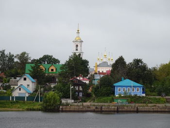 View of buildings and trees against sky