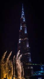 Low angle view of illuminated building at night