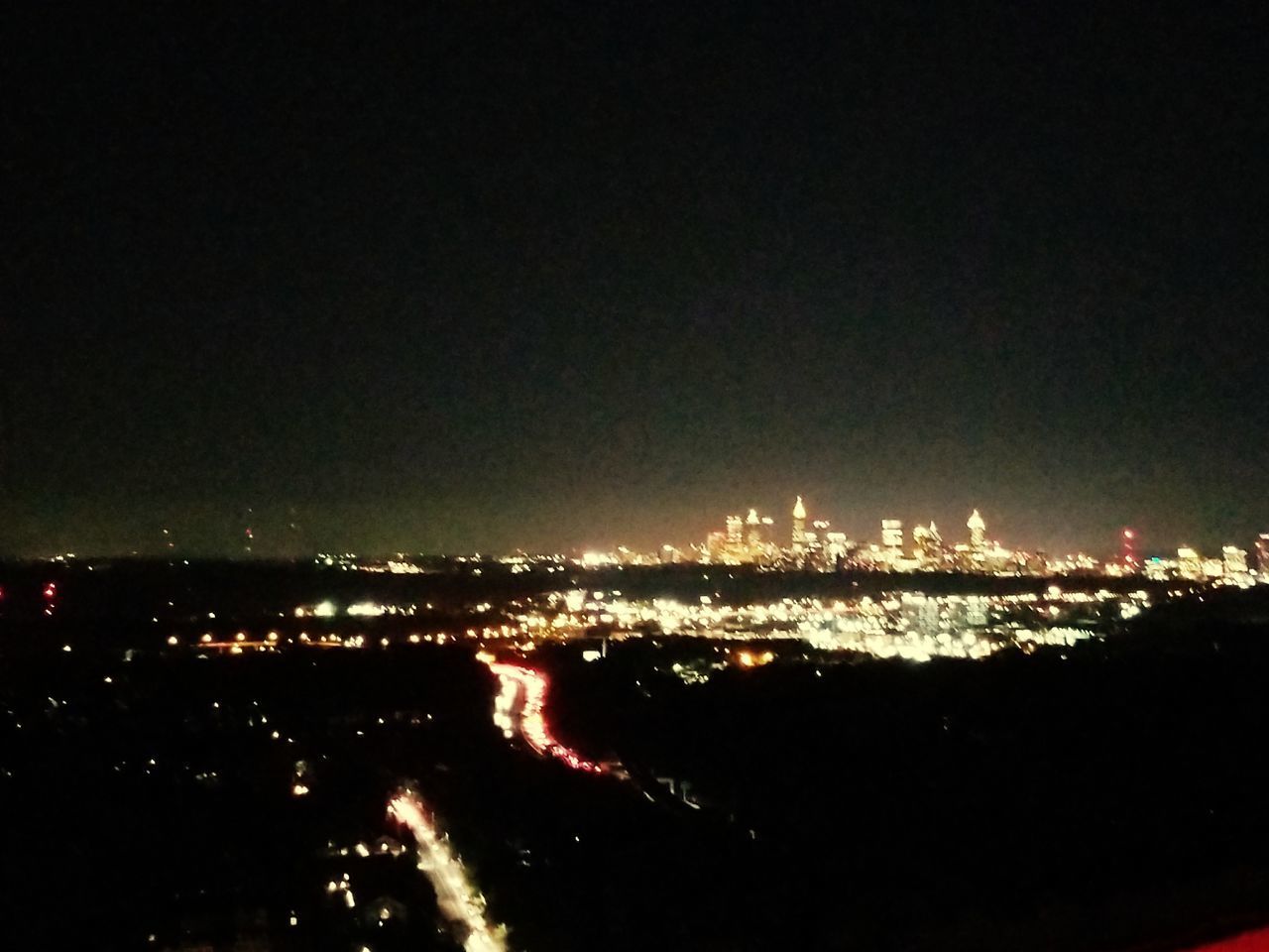 ILLUMINATED CITYSCAPE AGAINST SKY AT NIGHT