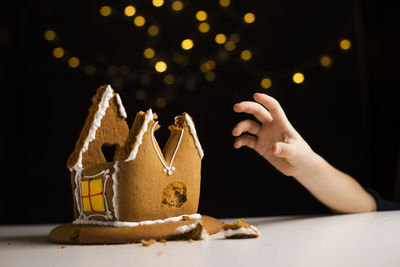 Midsection of person holding ice cream on table