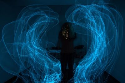 Light painting against silhouette man standing at night