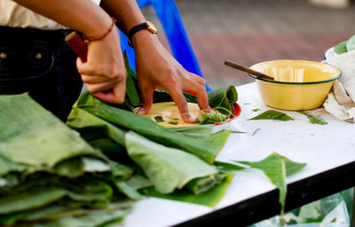 Midsection of person preparing food on table