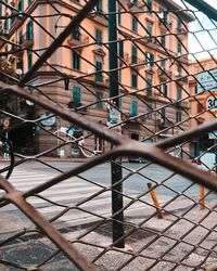 Close-up of metal fence by building