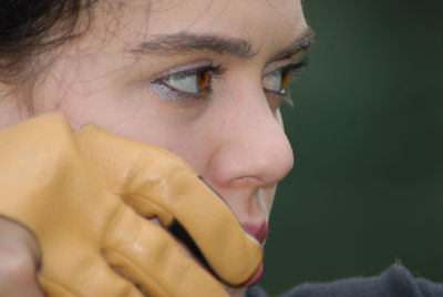 Close-up portrait of smiling young woman looking away