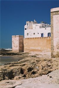 Low angle view of old building against clear blue sky