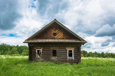 Built structure on field against sky