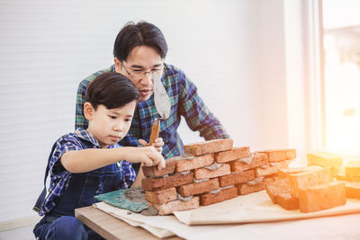 High angle view of father and son on table