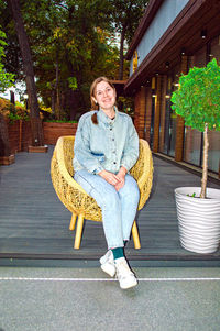 Portrait of woman sitting on hardwood floor