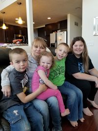 Portrait of happy friends sitting on floor