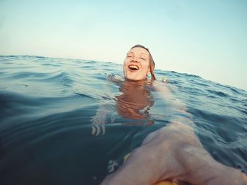 Portrait of smiling woman swimming in pool