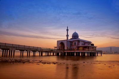 Mosque over sea against sky