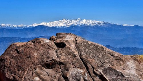 Scenic view of mountains against blue sky