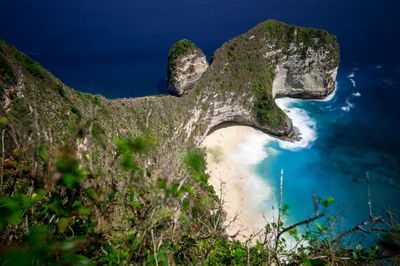High angle view of rocks by sea against sky