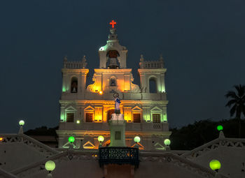 Statue of illuminated building at night