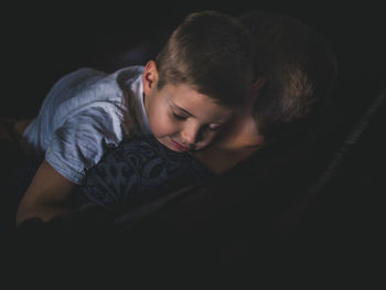 Boy sleeping with grandmother at home