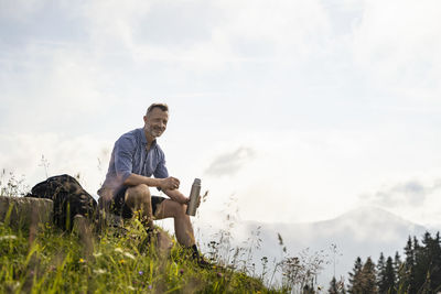 Man sitting against sky