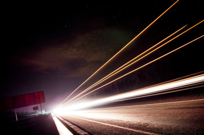 Low angle view of light trails at night