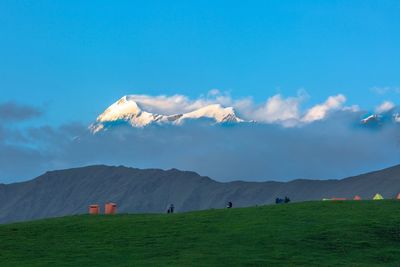 Scenic view of land and mountains against sky
