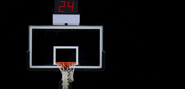 Low angle view of basketball hoop at night