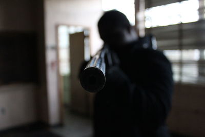 Close-up of man holding rifle