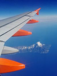 Airplane wing against sky