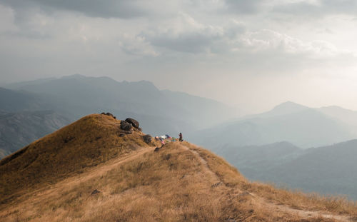 Woman on mountain against sky