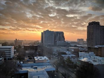 High angle view of buildings in city during sunset