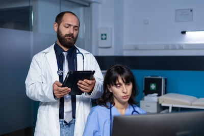 Doctor looking at digital tablet at hospital