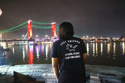 Rear view of woman standing in river