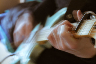 Close-up of man playing guitar