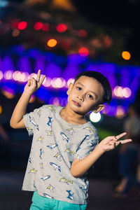 Portrait of cute girl playing at night