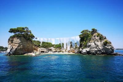 Scenic view of sea against clear blue sky