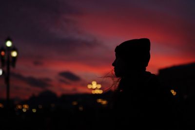 Portrait of silhouette woman against orange sky