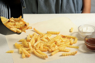 Midsection of woman holding food on table