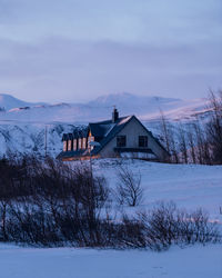 House on snow covered landscape