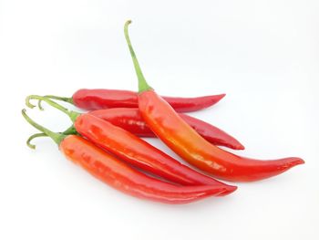Close-up of red bell peppers on white background