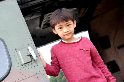 Portrait of boy standing at airplane door