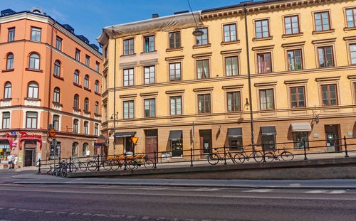 City street by buildings against sky