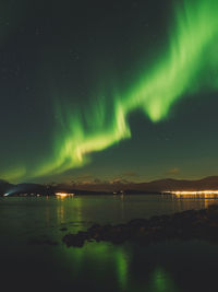 Scenic view of lake against sky at night