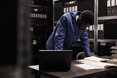 Side view of man working at office